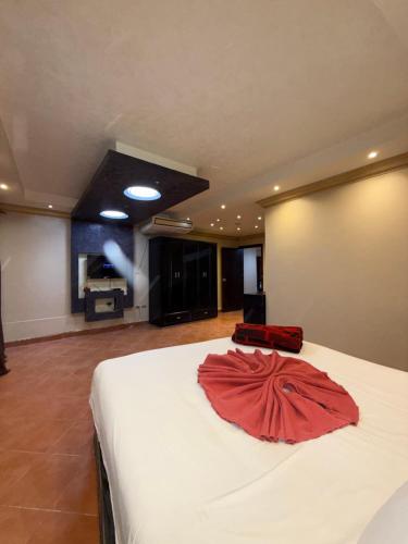 a bedroom with a bed with a red dress on it at Porto Sokhna Penthouse with Private Pool - MR in Ain Sokhna