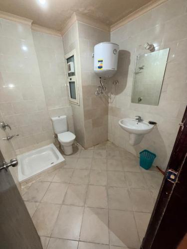 a bathroom with a toilet and a sink at Porto Sokhna Penthouse with Private Pool - MR in Ain Sokhna