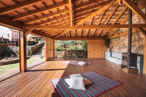 a large room with a wooden floor and a wooden roof at Terra Lodge in Ericeira