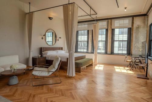 a bedroom with a bed and a living room at Sela V Hotel in Brooklyn