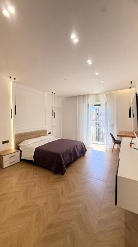 a bedroom with a bed and a wooden floor at La Dea Fuoco in Torre del Greco