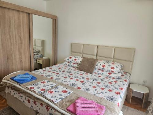 a bedroom with a large bed with a large mirror at Rooms Vlaovic in Herceg-Novi