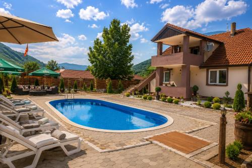 a swimming pool in the backyard of a house at Wooden Cabin 1 with Pool Access - Bate Bole Resort in Ohrid
