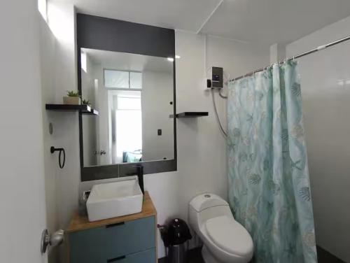 a bathroom with a toilet and a sink and a mirror at Sunset In Malabrigo in Puerto Chicama
