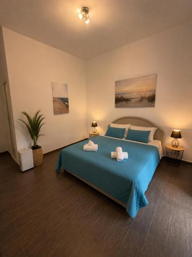 a bedroom with a blue bed with towels on it at Apartments Vista Muo 2026 NEWLY RENOVATED in Kotor