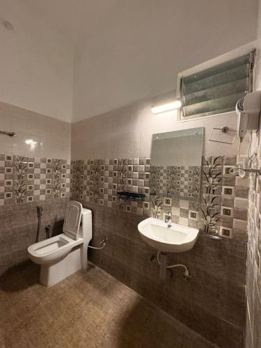 a bathroom with a toilet and a sink at The White Haven Kotagiri in Kotagiri