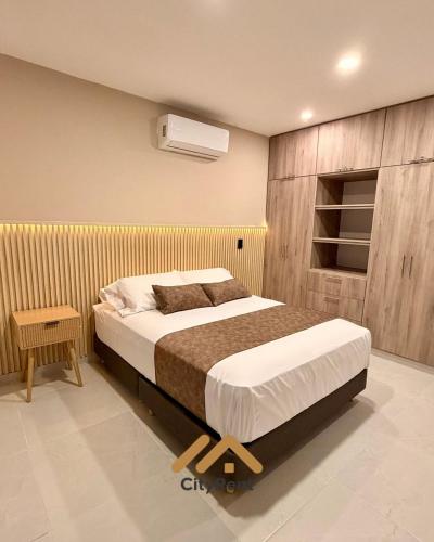 a bedroom with a bed with a wooden wall at Casa Martina premiun in Buga