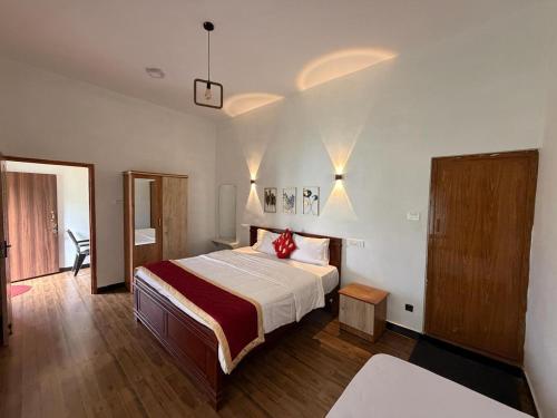 a bedroom with a bed and a desk in a room at The White Haven Kotagiri in Kotagiri