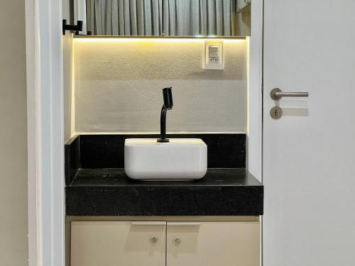 a bathroom counter with a white sink in a room at Cabo Branco - Legacy Suítes in João Pessoa