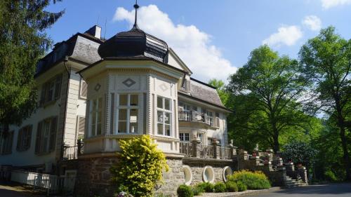 a building with a clock tower on top of it at Landsitz Kammerburg - Villa in Lorch am Rhein