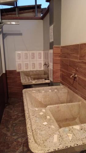 a bathroom with a large tub in a room at Valle Dorado Residence in Colcapirhua