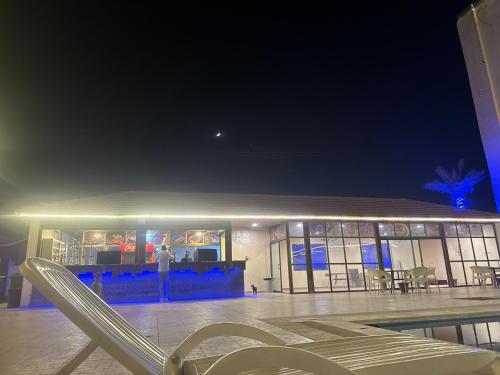 a man standing in front of a building at night at Astana in Sowayma