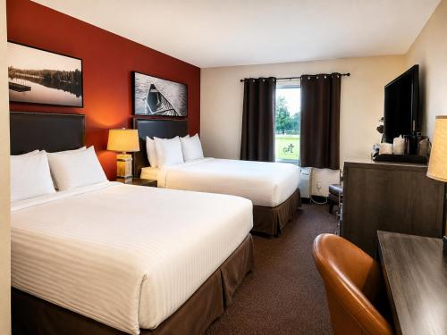a hotel room with two beds and a television at Quality Inn Fort Frances in Fort Frances