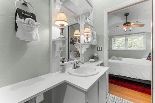a bathroom with a sink and a mirror and a bed at 826 Wilson Road in Highlands