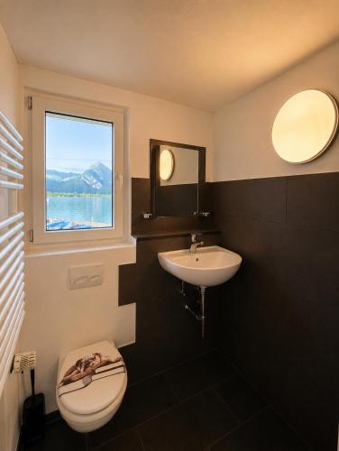 a bathroom with a sink and a toilet and a window at JSM è in Därligen