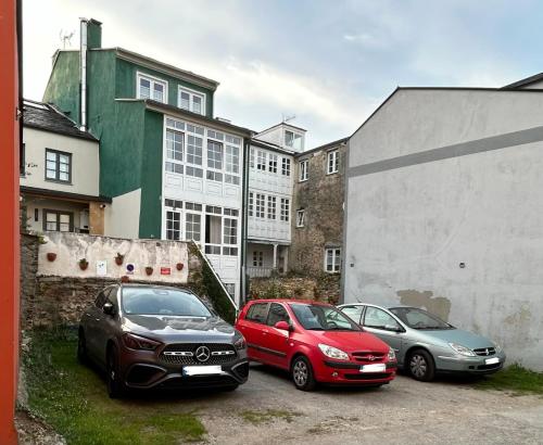 a group of cars parked in a parking lot at El Galeón in Ribadeo