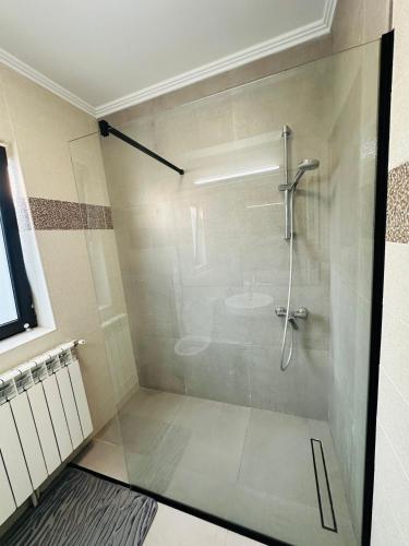 a shower with a glass door in a bathroom at Luxury 3 Bedroom Pool Villa in Gulia