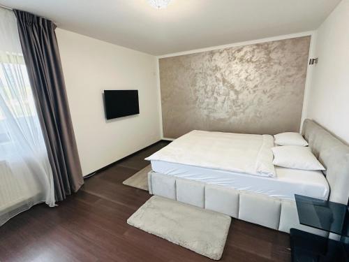 a bedroom with a white bed and a television at Luxury 3 Bedroom Pool Villa in Gulia