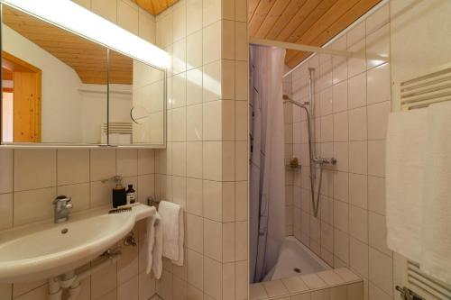 a bathroom with a sink and a shower at Dachnest in Unterwasser