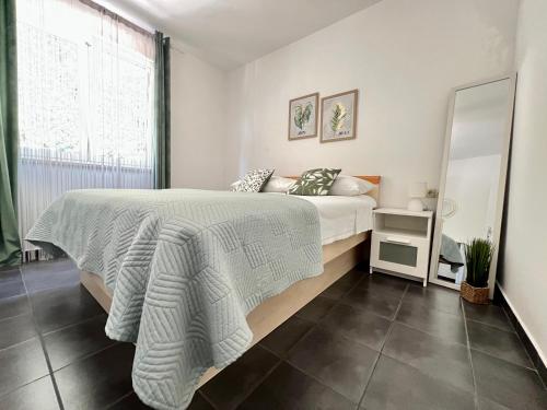 a bedroom with a bed and a large window at Rab City Apartment Greeny in Rab