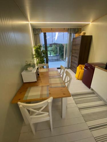 a dining room with a wooden table and chairs at Camping Abordaż Wolin in Kołczewo