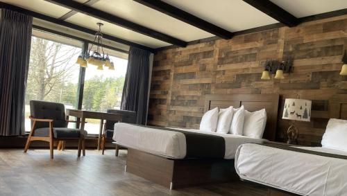 a hotel room with a bed and a dining room at Adirondack Lodge Old Forge in Old Forge