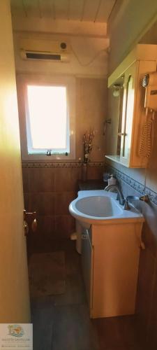 a bathroom with a tub and a sink and a window at Duplex in Pinamar