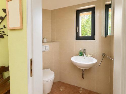 a bathroom with a sink and a toilet and a window at Wasserturm Putbus in Putbus