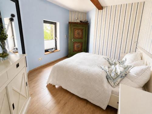 a bedroom with a white bed and a window at Wasserturm Putbus in Putbus