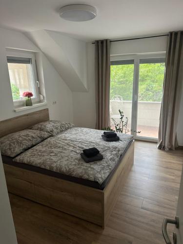 a bedroom with a bed with two black shoes on it at Green river apartments in Lancovo