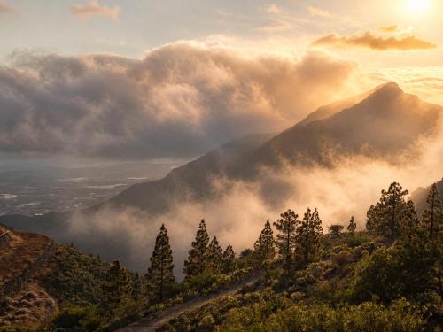 a view of a mountain range with clouds and trees at Jardines de Ifonche in Ifonche
