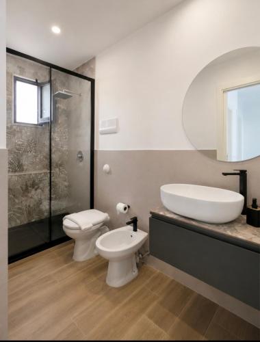 a bathroom with a sink and a toilet and a shower at Centro A Casuzza in Palermo