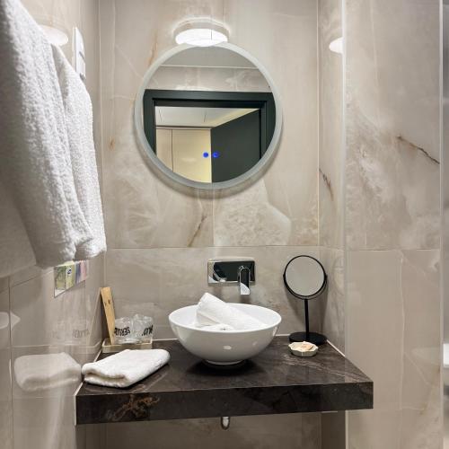 a bathroom with a sink and a mirror at Heritage Hall and More in Nagykálló