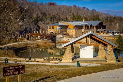 a building with a sign in front of a house at Echo Bluff State Park Lodge and Cabins in Eminence