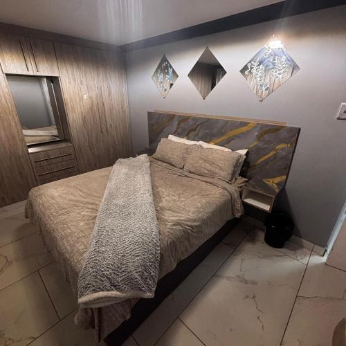a bedroom with a large bed and a television at BEREA apartment 786 in Durban