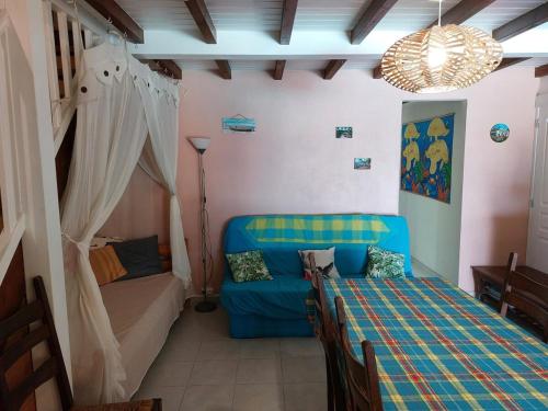 a living room with a couch and a bed at kazAnne in Pointe-Noire