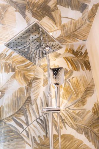 a painting of a floor with an umbrella on a wall at Lotus B&B in Messina
