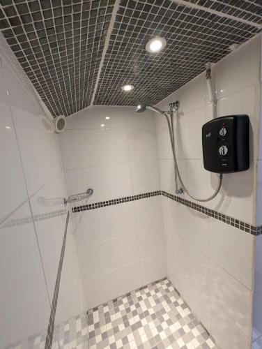 a bathroom with a shower stall with a shower at Cwmbach Guest House in Neath