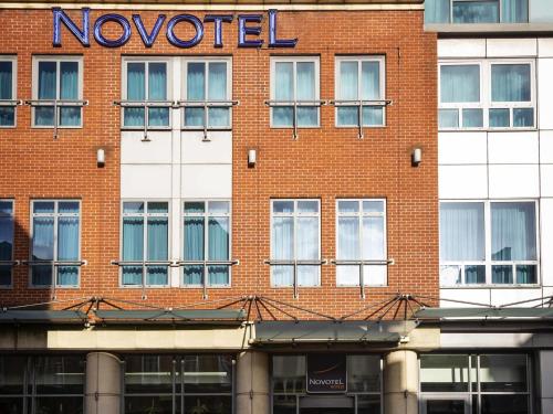 a red brick building with a noored sign on it at Novotel Reading Centre in Reading