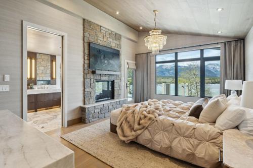 a large bedroom with a large bed and a fireplace at Sisu Lodge by Canmore Premier in Kananaskis Village