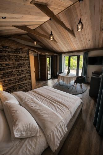 a bedroom with a large bed and a table at At the old blacksmith in Daugavpils