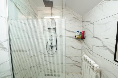 a shower with a glass door in a bathroom at Cabana Colț de liniste in Feldru