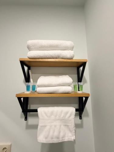 a stack of towels on a shelf with towels at In City Hotel in Yerevan