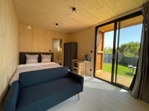 a bedroom with a bed and a large window at Chez Tib in Trégunc