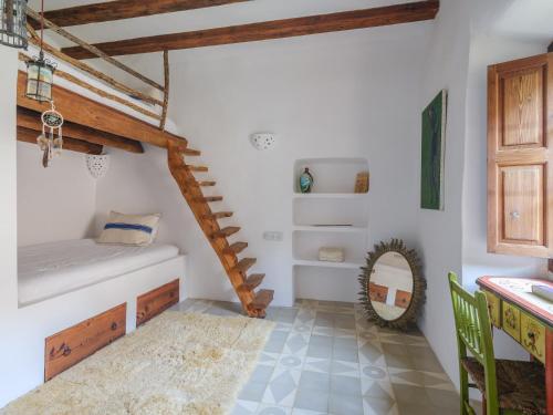 a bathroom with white walls and wooden beams at C'AN Sabuba in Deia