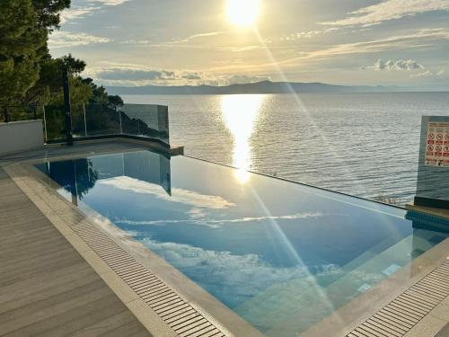 a swimming pool with a view of the water at ADRIA MIRIS apartments in Drasnice