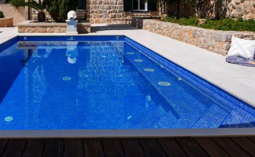a swimming pool with blue water in a house at Old Town Oasis in Dubrovnik