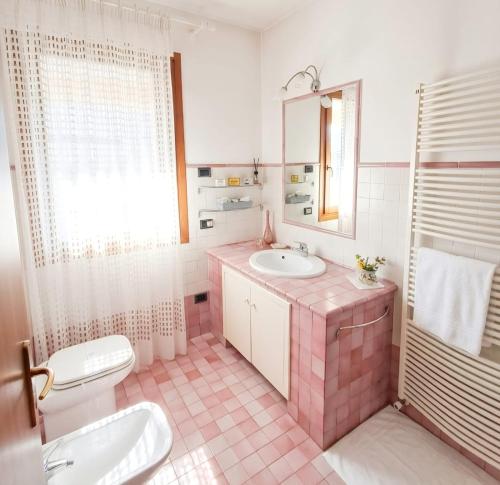 a bathroom with a sink and a toilet and a mirror at Casa Il Sogno in Vazzola