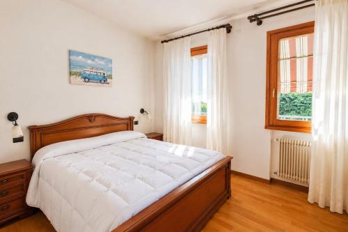 a bedroom with a large bed and a window at Casa Il Sogno in Vazzola
