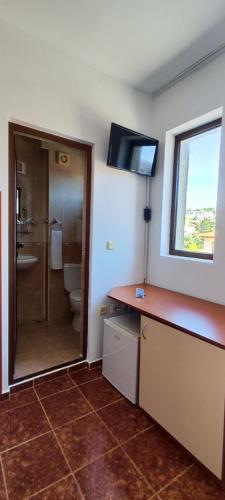 a bathroom with a sink and a toilet and a window at Хостел Бреза in Sunny Beach